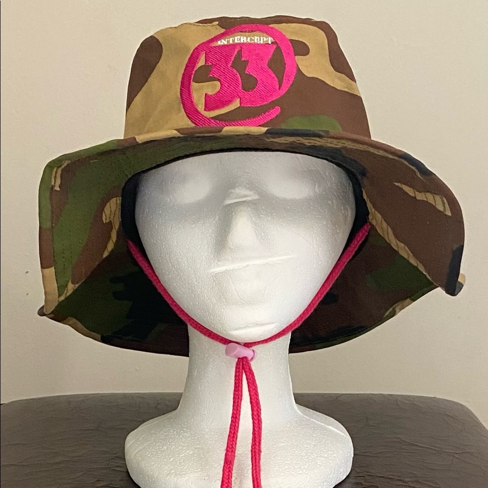 A brand new Medium size bucket hat in camouflage design with logo and drawstring